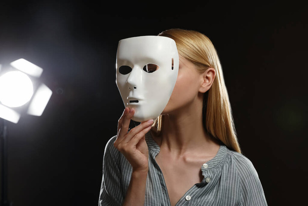 Professional actress with mask on stage in theatre - Foto, afbeelding