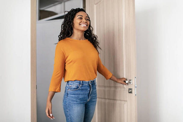 Cheerful Black Lady Entering Home Opening Door Indoors. Real Estate Female Buyer Coming Into Room In Her New Rented Apartment. Property Purchase And Ownership Concept - Foto, Imagem