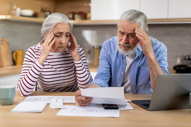 Stressed Senior Couple Checking Financial Papers And Planning Budget At Home, Upset Elderly Husband And Wife Looking At Loan Documents, Suffering Crisis While Calculating Family Spends, Closeup - Foto, Bild