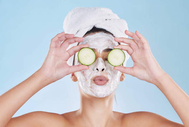 Skincare, beauty and face mask with cucumber slice on a beautiful woman taking care of her clean, healthy and natural skin. Fresh, wellness and relax during routine pamper spa cosmetology treatment. - Φωτογραφία, εικόνα