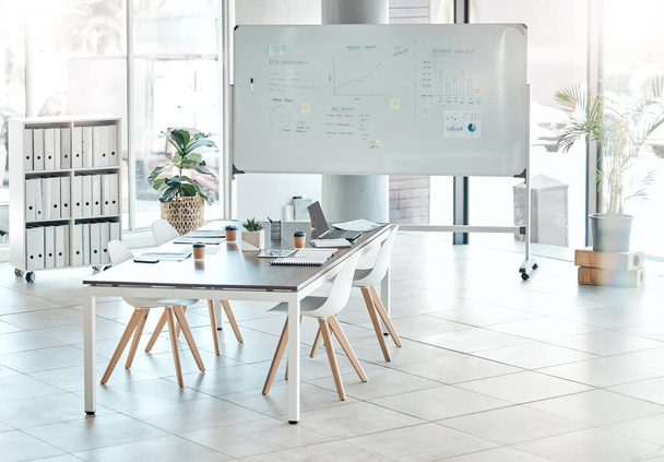 Boardroom, meeting or empty conference room with whiteboard, chairs and table interior of modern creative office space. Marketing data and charts for a business presentation, discussion of briefing. - Zdjęcie, obraz