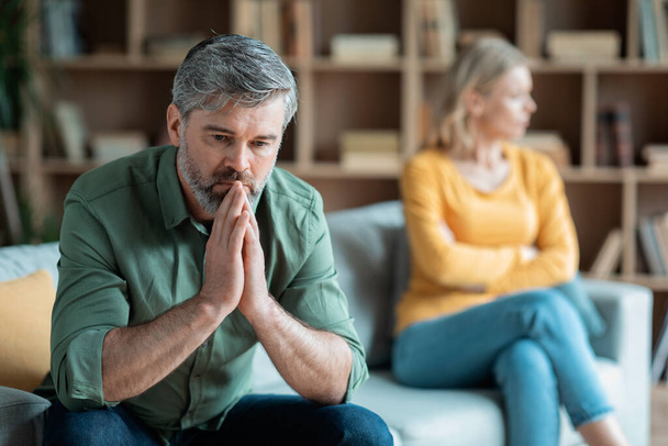 Marriage Problems. Portrait Of Middle Aged Wife And Husband Upset After Quarrel At Home, Offended Mature Spouses Ignoring Each Other, Suffering Relationship Crisis, Selective Focus At Pensive Man - Foto, Bild