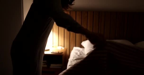Young woman lying in bed turning nightstand lamp light off, going to sleep - Imágenes, Vídeo