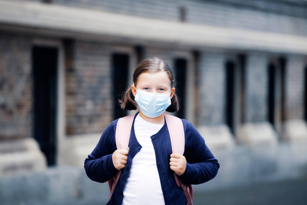 Child with face mask going back to school  - Foto, Imagem