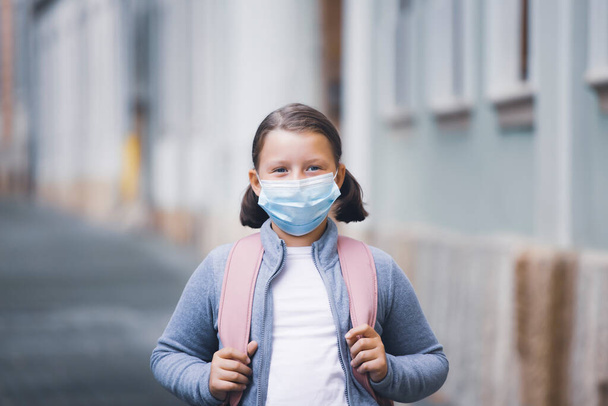 Child with face mask going back to school  - Photo, image