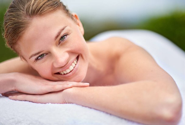 Fully relaxed at the beauty spa. Cropped portrait of a young woman lying on a massage table - Фото, изображение