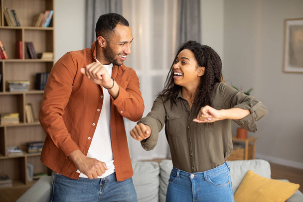 Happiness And Joy. Dating African American Spouses Having Fun Dancing Smiling To Each Other At Home. Weekend Leisure, Happy Marriage And Relationship Concept - Photo, Image