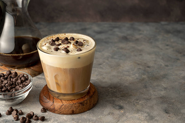 Coffee and vanilla ice crem with chocolate , coffee beans in glass cup, copy space. Lisestyle iced coffee drink - Fotó, kép