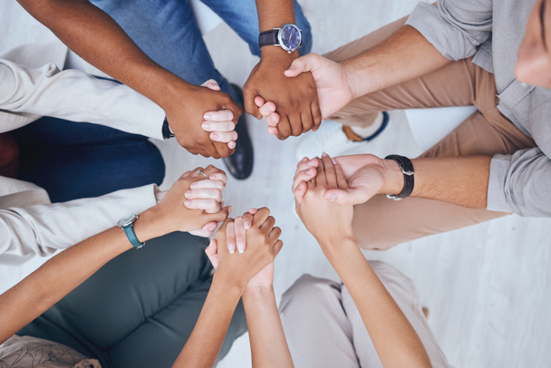 Support, prayer and trust with hands of people praying in spiritual faith and comfort in a meeting from above. Help, hope and worship with a group sitting in a circle of community and mental health. - Foto, imagen