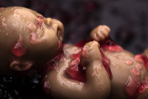 Abortion of a baby represented with a doll. Abortion concept. Artistic. Not real. - Foto, imagen