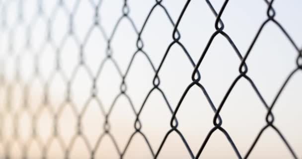 Chain link fence closeup. Mesh netting on gray background macro - Materiaali, video