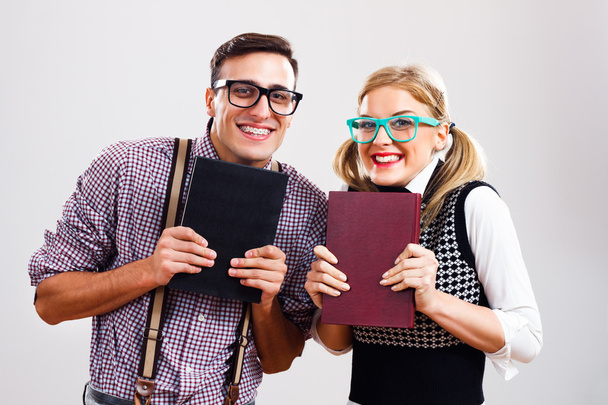 Nerdy man and woman with books - Фото, изображение