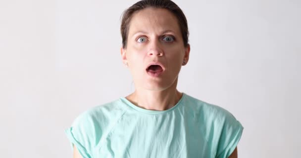 Portrait of beautiful emotionally shocked surprised woman. Woman looking surprised in complete disbelief positive human emotions - Imágenes, Vídeo
