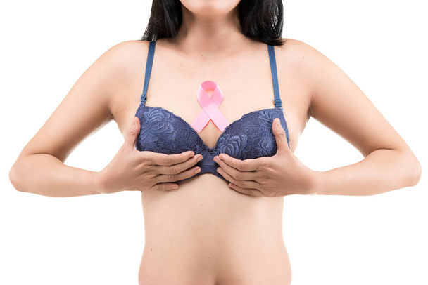 A woman in a blue bra shows a pink awareness ribbon isolated over white background. Breast cancer awareness - Photo, image