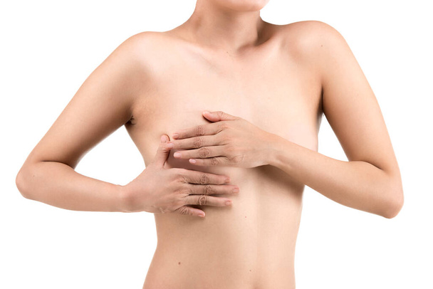 The woman holding her breast is isolated over white background. Breast cancer awareness - Φωτογραφία, εικόνα