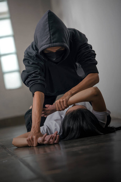 The scared woman is being abused with a man's hand on her hand. Woman abuse concept - Foto, imagen