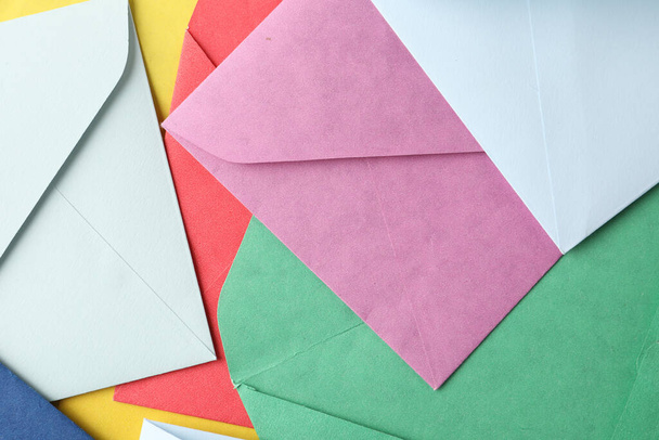 Colorful paper envelopes as background, top view - Fotó, kép