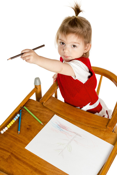 Little girl drawing showing a pencil - Photo, Image