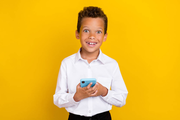 Photo of funny boy hand hold telephone modern device gadget rejoice good purchase isolated on yellow color background. - Fotoğraf, Görsel