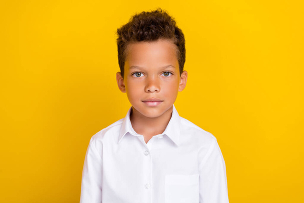 Photo of pretty cute boy dressed trendy white shirt ready first september isolated on yellow color background. - 写真・画像