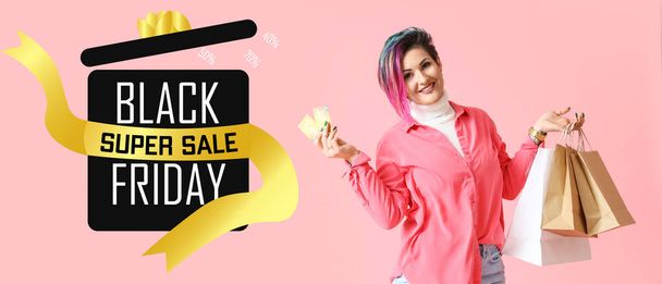 Beautiful woman with credit cards and shopping bags on pink background. Black Friday sale - Foto, afbeelding