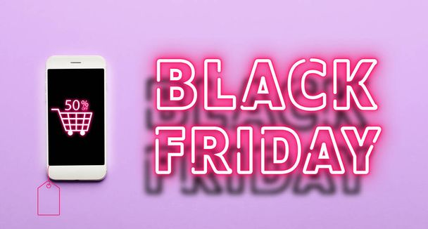 Mobile phone and text BLACK FRIDAY on lilac background - Fotó, kép