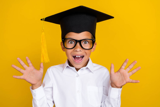 Portrait of surprised astonished boy raise opened hands unbelievable isolated on yellow color background. - Foto, immagini