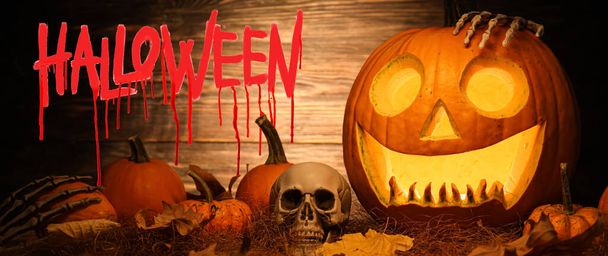 Greeting card for Happy Halloween celebration with pumpkins and human skull - Zdjęcie, obraz