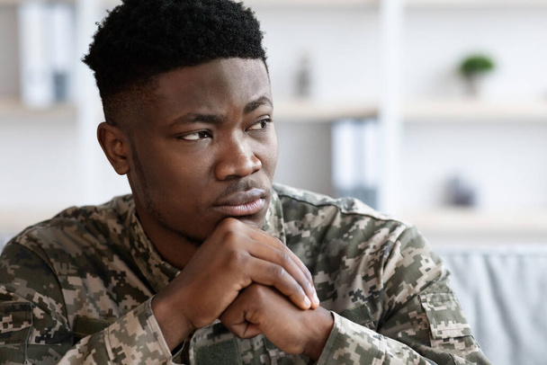 Serious short-haired young african american man in military uniform soldier looking at copy space, upset black soldier suffering from posttraumatic syndrome after service, closeup photo - Φωτογραφία, εικόνα