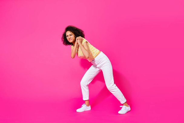 Full body size photo of young attractive gorgeous nice girl drag pull hard heavy object empty space isolated on pink color background. - 写真・画像