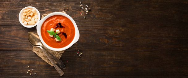 Autumn Homemade Tomato Soup with Bread Sticks, tomatoes, red pepper, herbs and spices on dark rustic wooden background. Top view, copy space. - Foto, imagen