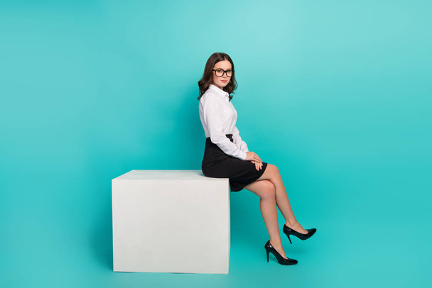 Full body photo of stunning lady professor sitting podium wait for partners isolated on cyan color background. - Foto, immagini