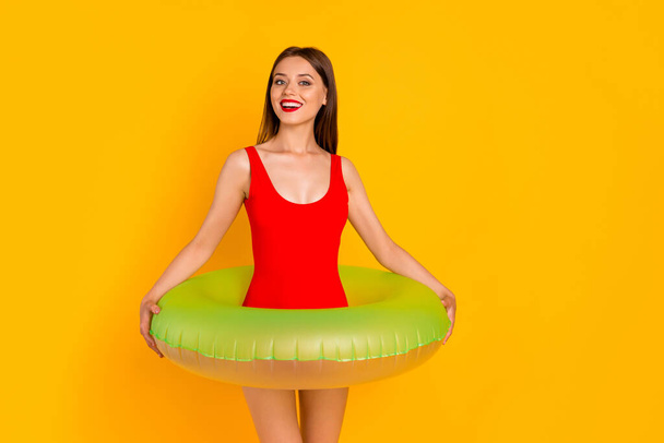 Photo of cute shiny woman wear swimsuit empty space standing inside buoy isolated yellow color background. - Фото, изображение