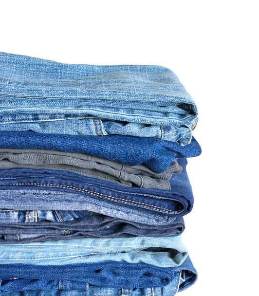 Stack on many jeans isolated on white close-up - Fotoğraf, Görsel