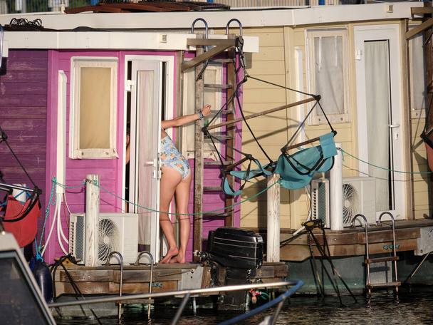 girl entering in a colorful houseboat - 写真・画像