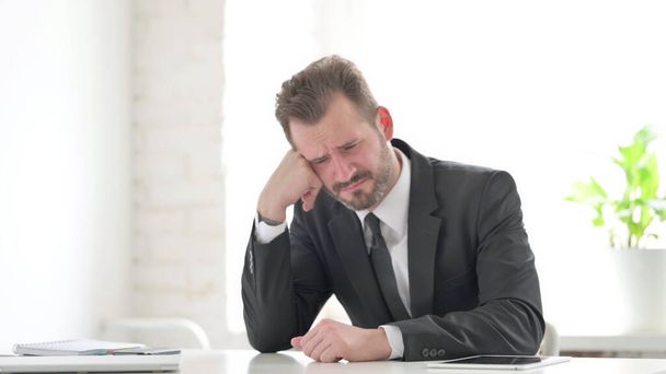 Businessman Feeling Stressed while Sitting in Office - Фото, зображення