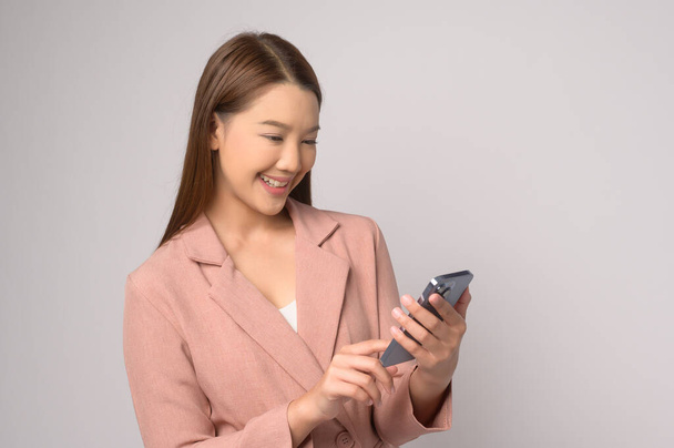 A Young asian woman using smartphone over white background, technology concept. 		 - Φωτογραφία, εικόνα