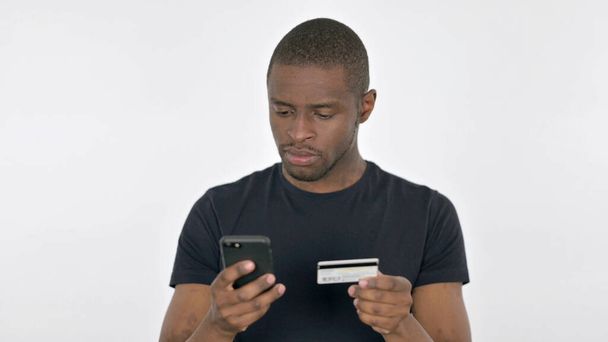 Online Shopping on Smartphone by African Man on White Background - Valokuva, kuva