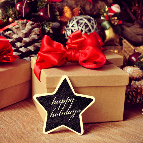 Gifts and text happy holidays in a star-shaped chalkboard - Foto, Bild