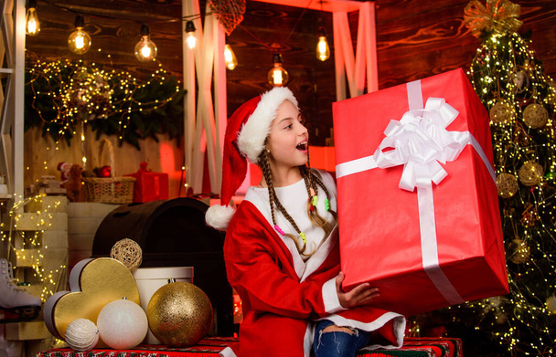 Child having fun christmas eve. Happiness and joy. Girl Santa claus received gift. Best gift for her. Shop purchase. Happy new year. Big surprise. Winter gift. Generous holiday. Rewarding concept. - Foto, Imagem
