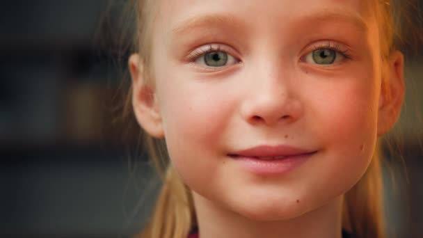Portrait cute caucasian little preschool girl daughter toddler pretty talented kid friendly female face beautiful blonde baby with green eyes smiling looking at camera happy small child enjoy holidays - Filmmaterial, Video