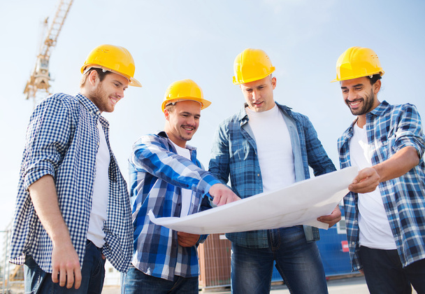group of builders with tablet pc and blueprint - Foto, Imagen