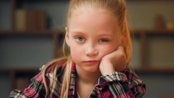 Close up portrait little offended child sad upset bored preschool girl pretty blonde female kid look at camera sit at home alone sweety daughter feel sadness after quarrel punishment for bad behavior - Imágenes, Vídeo