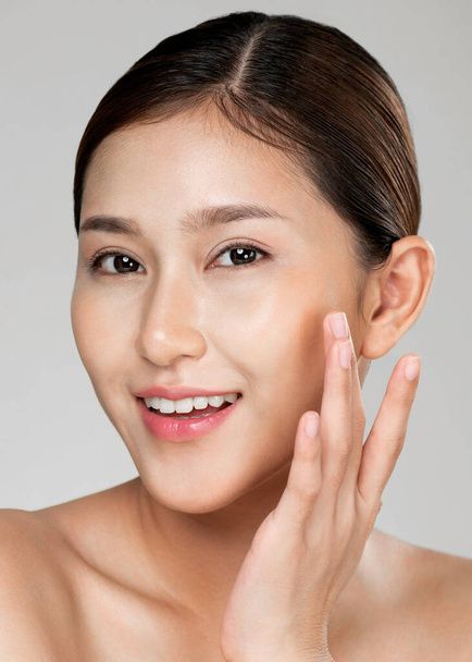 Closeup ardent young woman with healthy clear skin and soft makeup looking at camera and posing beauty gesture. Cosmetology skincare and beauty concept. - Fotó, kép