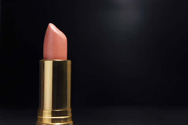 Golden Lipstick for Pink Color, in Black background for Advertising. - Photo, Image