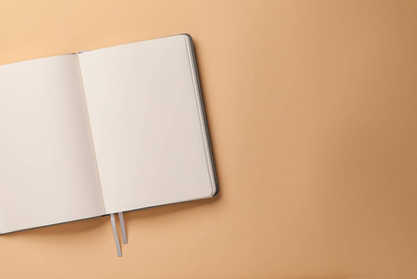 Blank notebook on beige background, top view. Space for text - Zdjęcie, obraz