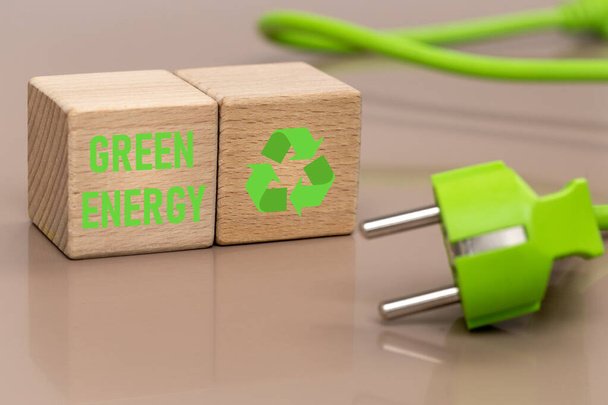 Green power plug, The concept of acquiring modern energy sources, environmentally friendly, Green energy written on a wooden block - Foto, Imagen