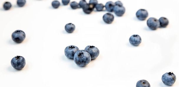 Fresh blueberries on a white background. The concept of healthy and dietary food - Photo, Image