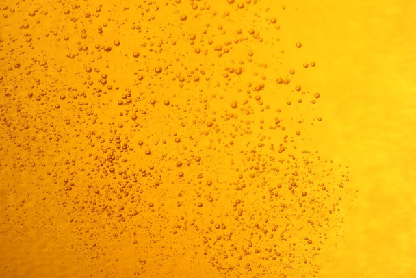 Tasty beer with bubbles as background, closeup - Foto, imagen