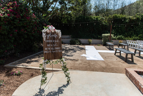 Wedding ceremony sign shows all inclusive seating assignment with freedom to sit on either side of the isle. - Photo, Image